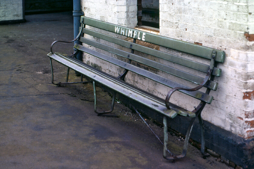 Ex SR bench, Whimple station 
 A general air of decay and a lack of care had enveloped Whimple station with it in receipt of a very poor level of service by this stage in 1981. A survivor from pre-Britsih Railways days appears to be this bench painted in a somewhat faded Southern Railway green paint with the station's name hand-painted. It was located on the down platform that has now been removed and the area flattened with the single track now serving the former up platform. 
 Keywords: Ex SR bench Whimple station