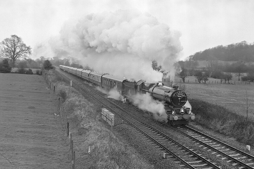 6000, outward leg of The Welsh Marches Express, 10.15 Crewe-Newport, Little Stretton SO463951 
 Making a fine display of exhaust 6000 'King George V' leads the southbound Welsh Marches Express on the approach to Church Stretton. The charter, one of a number on this line throughout 1981 and 1982, started from Crewe being diesel hauled with the King taking over at Shrewsbury. At this stage in the day, the weather was pretty awful with rain and heavy cloud making film photography a little tricky witnessed by the slight motion blur in this image. 
 Keywords: 6000 The Welsh Marches Express 10.15 Crewe-Newport Little Stretton SO463951 King George V