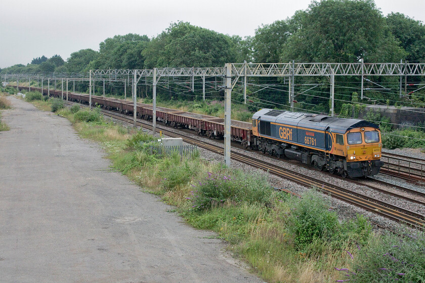 66781, 12.30 North Wembley Junction-Bescot (7G52, 7L), site of Roade station 
 The second northbound infrastructure of the day heads north in almost a repeat of the first gave me enough time to nip home and have some lunch! This time, 66781 'Wensleydale Railway Association 25 Years 1990-2015' leads the 12.30 North Wembley to Bescot running as 7G52 (the first being 6G51) pass the site of Roade station leading a set of MOA low-sided bogie box wagons dubbed as 'monsterboxes'. Right at the rear of the train were a couple of lone Plasser & Theurer TJC60 self-propelled heavy-duty twin jib cranes numbered DRP78210 and DRP78215 in Balfour Beaty's white p[aintscheme. 
 Keywords: 66781 12.30 North Wembley Junction-Bescot 7G52 site of Roade station Wensleydale Railway Association 25 Years 1990-2015 GBRf