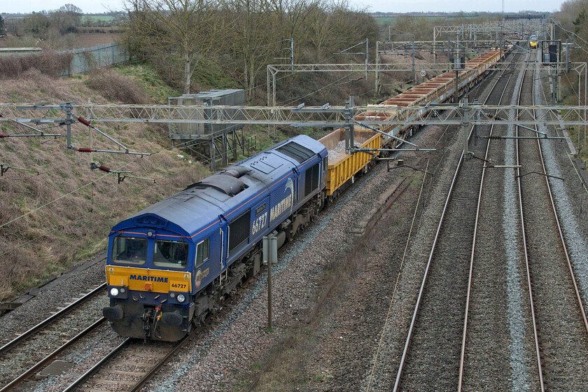 66727, 08.50 Alexandra Palace-Bescot Down sidings (9G63, RT), Victoria bridge 
 My quest to photograph all six of the Maritime liveried and named Class 66s continues! With a number of photographs 'in the bag' of 66727 'Maritime One' today would disappoint again! The 66 leads the 08.50 Alexandra Palace to Bescot engineering train past Victoria bridge just south of Roade. Notice the Pendolino bearing down on the train. 
 Keywords: 66727 08.50 Alexandra Palace-Bescot Down sidings 9G63 Victoria bridge Maritime One