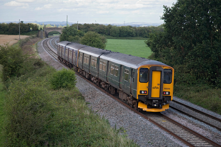 150248 & 150221, GW 16.58 Yeovil Pen Mill-Bristol Temple Meads (Cancelled Weymouth-Yeovil Pen Mill) (2V86, 1E), Berkley ST802494 
 In its GW green livery that seems to do its best to blend in with the summer countryside, 150221 (with 150248) work the 16.58 Yeovil Pen Mill to Bristol past Berkley between Frome and Westbury. These class 150s have been the mainstay of local workings in this area for many years but things are set to change with the introduction of new units cascaded from from other areas. 
 Keywords: 150248 150221 2V86 Berkley ST802494