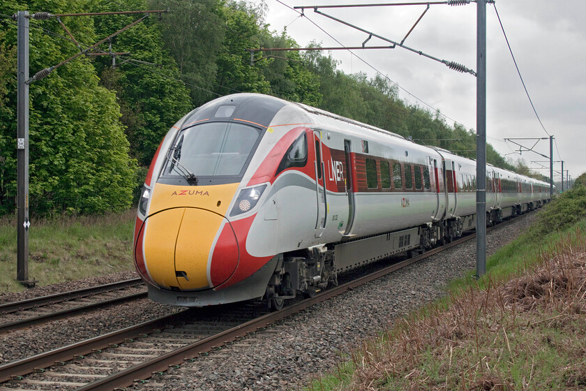 801202, GR 09.03 London King's Cross-Leeds (1D07, RT), Penny's crossing SK630970 
 Andy and I were somewhat surprised to find Azuma operation almost back to normal following the previous week's debacle that led to the temporary withdrawal of the entire fleet along with all other types elsewhere in the country due to frame cracking. Whilst GWR have still struggled to get their sets back in service the LNER sets, which are considerably newer than their IET counterparts, appear to have fared better. 801202 works the 09.03 King's Cross to Leeds service past Penny's Lane near New Rossington. 
 Keywords: 801202 09.03 London King's Cross-Leeds 1D07 Penny's crossing SK630970 LNER Azuma