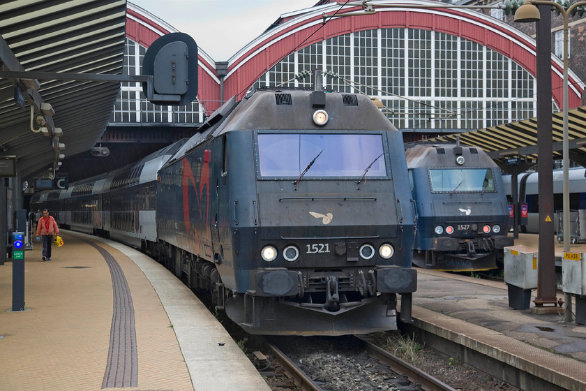 1521 & 1527, unidentified workings, Copenhagen Central station 
 Two DSB ME diesels wait noisily at the southern end of Copenhagen Central station. 1521 to the left will leave towards me whilst 1527 to the right will depart for sterport. In a world where the drive for electrification seems relentless, I am not at all sure how much longer these Henschel built railway dinosaurs will be around? 
 Keywords: 1521 1527 Copenhagen Central station