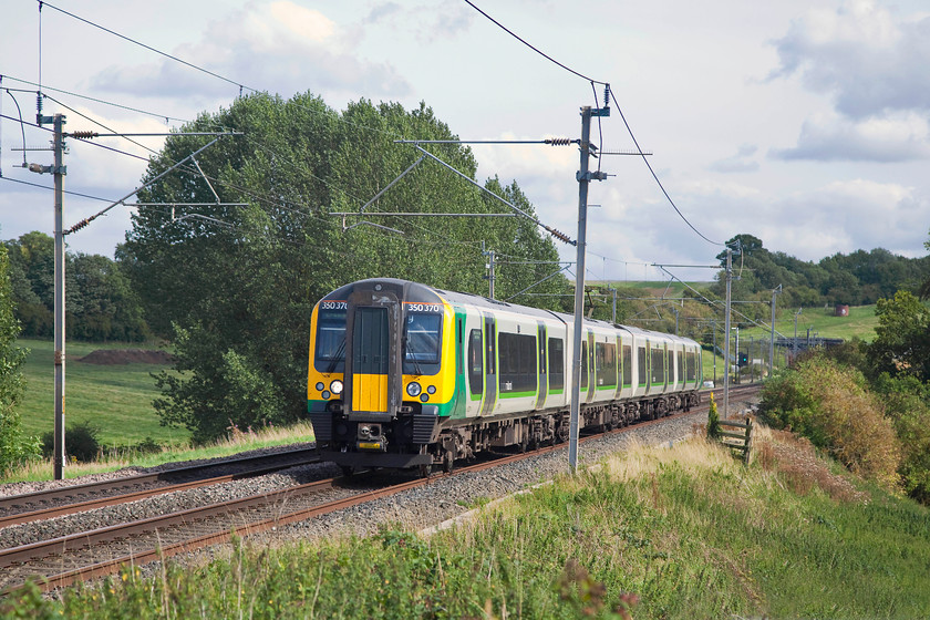 350370, LM 14.46 London Euston-Crewe (1U39, RT), Weedon SP636588 
 350370 is working the 14.46 Euston to Crewe service. It has just emerged from Stowe Hill tunnel the parapet of which can just be seen in the distance. Stowe Hill Tunnel is about a mile south of Weedon on the southern WCML in Northamptonshire. 
 Keywords: 350370 1U39 Weedon SP636588