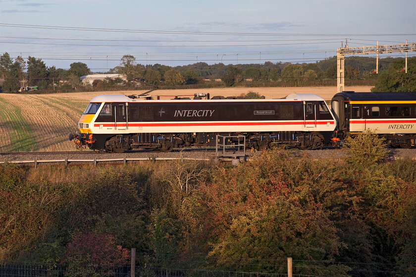 90001, 17.42 London Euston-Manchester Piccadilly (1Z41, 2E), Roade hill 
 At last in some evening sunshine at this location between Roade and Ashton 90001 'Royal Scot' passes heading north on the down fast line leading LSL's 17.42 Euston to Manchester 'charter'. I put the word charter in inverted commas as it is for all intents and purposes a service train with anybody welcome to turn up, board it and pay the 75 first-class flat fare for a journey in some very comfortable and roomy Mk. III coaches. As LSL has now extended the services until the beginning of December and with the possibility of a Monday service being introduced it is obviously going down well with the travelling public and the enthusiast alike! 
 Keywords: 90001 17.42 London Euston-Manchester Piccadilly 1Z41 Roade hill Royal Scot