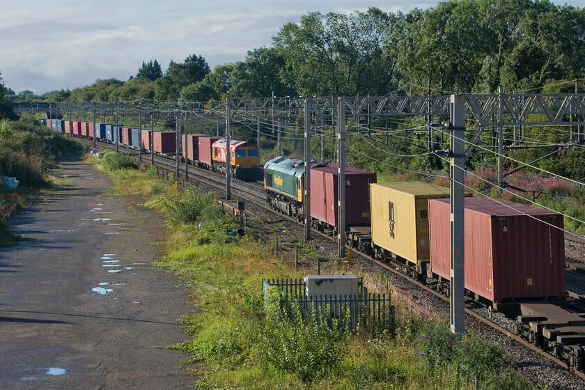 66523, 03.39 Garston-London Gateway (4L52, 2L) & 66783, 03.10 Felixstowe North-Trafford Park (4M18, 3E), site of Roade station 
 A passing of freights at Roade sees 66523 heading south leading the 03.39 Garston to London Gateway 4L52 as Biffa liveried 66783 'The Flying Dustman' heads north with the 4M18 03.10 Felixstowe to Trafford Park service. The latter of these Class 66s is not one that I have very many photographs of and so was a little dispapointed to get this distant one at Roade! 
 Keywords: 66523 03.39 Garston-London Gateway 4L52 66783 03.10 Felixstowe North-Trafford Park 4M18 site of Roade station Freightliner Biffa The Flying Dustman