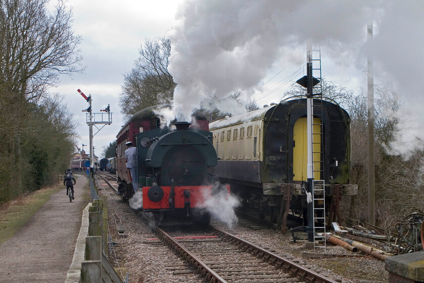 2104, 12.30 Pitsford & Brampton return, Bridge 13 
 From this angle, the cut-down loading gauge of Peckett 2104 is clear to see when compared to the Mk. I coach that it is pushing. It was built like this, along with two others (2103 and 2105), to work at Croydon power station in South London, something that it did from 1948 until superseded by diesels in the 1960s. The Peckett is approaching Pitsford and Brampton station working the 12.20 return Easter special service. 
 Keywords: 2104 12.30 Pitsford & Brampton return Bridge 13 Peckett