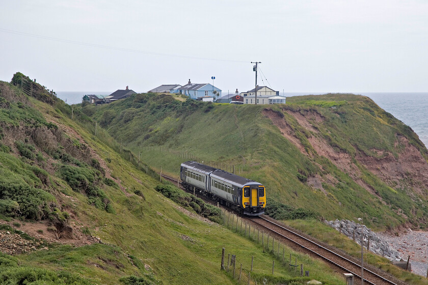 156482, NT 13.07 Carlisle-Lancaster (2C54, RT), Nethertown 
 I could not resist another photograph of the 13.07 Carlisle to Lancaster service from my vantage point above the line at Nethertown. 156482 is working the train past some holiday accommodation on the cliff top. On a grey and calm day like this I am sure that they are nice places to spend some time in but when a westerly storm is blowing in off the Irish Sea in November I bet that it feels a little different! 
 Keywords: 156482 13.07 Carlisle-Lancaster 2C54 Nethertown