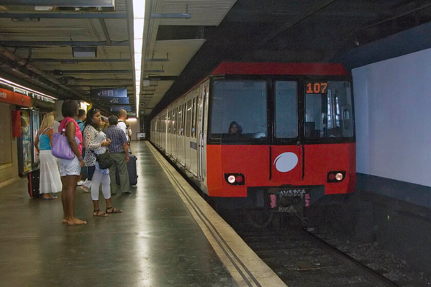 Line 1 stock, TMB Hospital de Bellvitge-Fondo working, Universitat station 
 A TMB series 3000 stock arrives at Barcelona's Universitat station. Introduced in 1984 this stock was the first word in modernity when new incorporating a number of very modern features such as ATO (automatic driving, although assisted by the rider), air conditioning, a public address system with automatic announcements, line plans with LED technology and indicators on the side of door opening; all today things that we have come to expect. 
 Keywords: Line 1 stock TMB Hospital de Bellvitge-Fondo working Universitat station