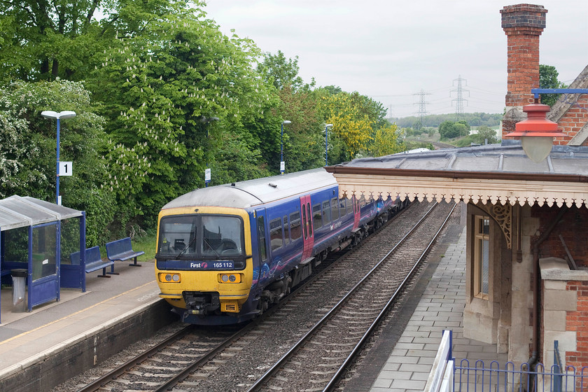 165112, GW 13.27 London Paddington-Oxford (2N40, 4L) Culham station 
 165112 leaves Culham station with the 13.27 Paddington to Oxford 2N40 stopper service. Looks can be deceiving, the platform to the right is in fact not a platform. It's isolated from use with the adjacent building in use by a private company. The passenger platform is beyond the building out of view. 
 Keywords: 165112 2N40 Culham station