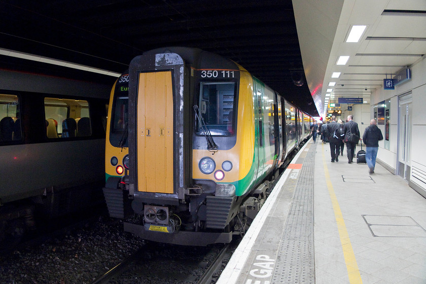 350111, LM 16.14 Birmingham New Street-London Euston (2Y46), Birmingham New Street station 
 After watching China's Lin Dan win the men's singles final of the Yonex All England badminton open beating Tian Houwei, my son and I went back to New Street for our train home. Sitting in the gloom of the station, 350111 waits to leave and take us back to Northampton working the 16.14 Birmingham New Street to London Euston. 
 Keywords: 350111 16.14 Birmingham New Street-London Euston 2Y46 Birmingham New Street station