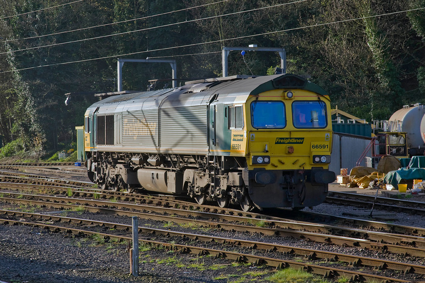 66591, stabled, Ipswich yard 
 The driver of 66591 sits in his cab awaiting instructions from the signaller as to when he can leave Ipswich yard and head light engine to Felixstowe. This particular Class 66 arrived in the UK from its North American birthplace in April 2007 and has been in service with Freightliner since. 
 Keywords: 66591 stabled Ipswich yard Freightliner