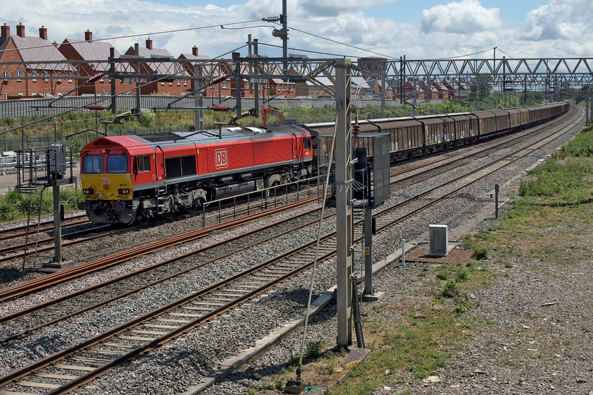 66107, 07.05 Dollands Moor-DIRFT (6M45, 1L), site of Roade station 
 A DB Cargo locomotive always brings a bit of colour to a photograph. 66107 leads the seven days a week 6M45 07.05 Dollands Moor to Daventry bottled water train through Roade. I have a number of photographs of this member of the class but this is my only one in its smart DB livery with all the others taken when it wore its EWS paintwork. 
 Keywords: 66107 07.05 Dollands Moor-DIRFT 6M45 site of Roade station DB