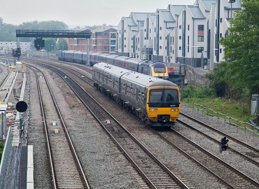 165101, GW 10.18 London Paddington-Evesham (1W02, 12L) & 43159, stabled, Oxford Carriage Sidings, Walton Well Bridge 
 Great Western 165101 leaves Oxford working the 1W02 10.18 London Paddington to Evesham service. It is passing 43159 stabled in the west siding just north of Oxford station. The picture is taken from Welton Road Bridge, a location busy with pedestrians and cyclists coming in and out of Oxford. 
 Keywords: 165101 1W02 43159 Oxford Carriage Sidings Walton Well Bridge