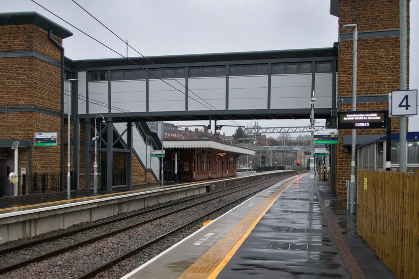 Looking north along platforms 3 & 4, Wellingborough station 
 The first time that I have stood this far east on Wellingborough station! The recently remodelled and extended platform three is seen from the totally new platform four. The original brick island-building remains as does the northern section of the platform but all the rest are new. I must give some credit to the design and construction of the steps and lift towers that incorporate facing brickwork similar to much in this area of the country being of a Northamptonshire ironstone material. 
 Keywords: Looking north platforms 3 & 4 Wellingborough station