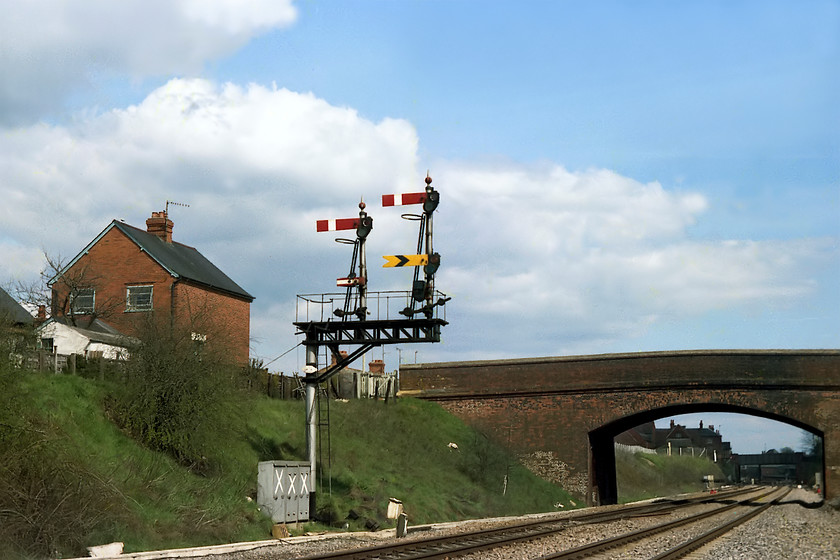 Newbury up home bracket 
 The magnificent up home bracket signal on the approach to Newbury. The home and distant to the right are for the up fast. The left home is for the up platform and has a subsidiary arm below it allowing trains to proceed at caution past the home set at danger, for example if a train was already occupying the platform ahead. 
 Keywords: Newbury up home bracket