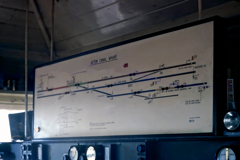 Track diagram, Acton Canal Wharf Signal Box 
 We were afforded a visit inside Acton Canal Wharf signal box by the signalman. I remember the box being a warm and welcoming place with a fire blazing, keeping it warm. The track diagram is seen above the levers. The box is located eight and a half miles from St. Pancras via Cricklewood according to the milepost directly outside the box. 
 Keywords: Track diagram Acton Canal Wharf Signal Box