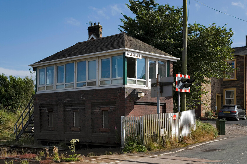 Silecroft signal box (Furness, 1923) 
 Silecroft signal box is a Furness Railway Company Type 4 design fitted with a thirty-five lever Railway that was opened in 1923 by the London Midland & Scottish Railway Company replacing an earlier signal box located diagonally across the level crossing on which I am standing. I last photographed this box on a visit in 1986. Then I stood at the other end of the box in the former goods yard. The box looked considerably more decrepit then but it was a dull and cold day in early spring! Once the photograph has been scanned and uploaded, a link will be placed here. 
 Keywords: Silecroft signal box Furness