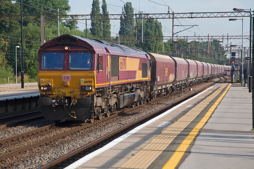 66090, 02.19 Peak Forest-Bletchley (6B10), Northampton station 
 Former EWS 66090 still wears its previous operators livery but with DB vinyls applied to the front and to the cab end. It leads the 02.19 Peak Forest to Bletchley stone train that can usually be caught at about this time on a Saturday morning if it's routed this way rather than via the Midland and Marston Vale line. 
 Keywords: 66090 02.19 Peak Forest-Bletchley 6B10 Northampton station