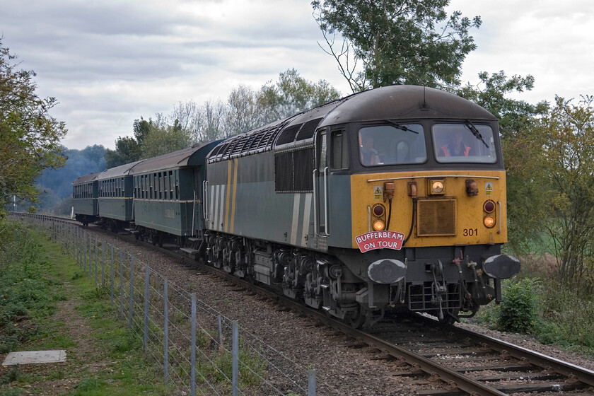 56301, 13.22 Wansford-Peterborough Nene Valley (1E50), Wansford TL099980 
 An easy job for 56301 as it accelerates away Wansford working the 13.22 gala service to Peterborough Nene Valley. Whilst the sets of continental stock that the NVR operates are not always popular with enthusiasts, behind the Class 56 seen here in this livery they do not look particularly out of place. 
 Keywords: 56301 13.22 Wansford-Peterborough Nene Valley 1E50 Wansford TL099980Grid