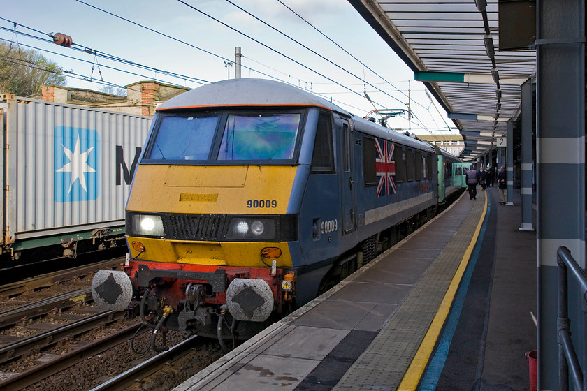 90009, LE 07.05 Norwich-London Liverpool Street (1P13), Ipswich station 
 Still looking very smart from work completed in 2012 as part of the Queen's Diamond Jubilee 90009 stands at Ipswich station leading the 07.05 Norwich to Liverpool Street service. The locomotive is still sporting the former ONE livery with no evidence of it now being operated by Greater Anglia but it does have red buffer beams, silver cab roofs and a large Union Jack on both sides as well as its 'Diamond Jubilee' nameplates. I sys[etc that it will not remain in this livery for much longer as Abellio continue their rebranding a costly and wasteful part of of our ridiculous privatised railway! 
 Keywords: 90009 07.05 Norwich-London Liverpool Street 1P13 Ipswich station Abellio Greater Anglia Diamond Jubilee