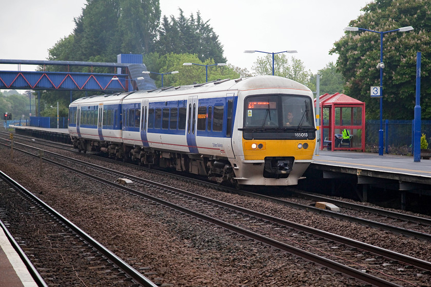 165013, CH 07.01 London Marylebone-Banbury (2U10, 2L), Princes Risborough station 
 165013 pauses at Princes Risborough station with the 07.01 Marylebone to Banbury stopper service. For late May it ws a very dull and wet day that put a bit of a dampener on the occasion, namely Chiltern's final use of their class 121 'Bubble car' DMU. 
 Keywords: 165013 2U10 Princes Risborough station