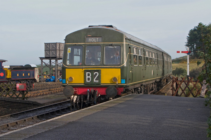 M51192 & M56352, 11.15 Sheringham-Holt, Weybourne station 
 M51192 leads M56352 into Weybourne station working the 11.15 Sheringham to Holt North Norfolk Railway service. With its two-character headcode box, the front end of the leading car than the trailing one that retains its BR high-intensity light. However, looks can be deceiving as this panel has only recently been fitted and is a dummy with the display fixed reading B2. Ex GER 564 puts in an appearance in the station yard to the left of the water tower. 
 Keywords: M51192 M56352 11.15 Sheringham-Holt Weybourne station NNR Poppy Line Class 101 DMU