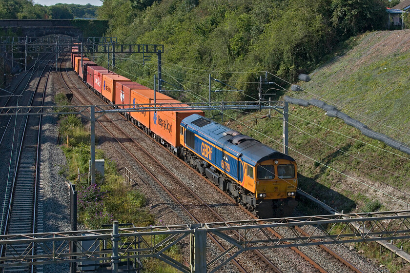 66729, 13.57 Birch Coppice-London Gateway (4L68, RT), A508 bridge 
 The 4L68 13.57 Birch Coppice to London Gateway freight passes through Roade worked by GBRf's 66729 'Derby County'. The train is about to pass under the former A508 road bridge which is now a far more pleasant place to stand and take photographs since the opening of the village's bypass last September. Notice the embankment clearance to the right of the train. This has been undertaken in the last few weeks with stabilisation work then taking place. 
 Keywords: 66729 13.57 Birch Coppice-London Gateway 4L68 A508 bridge Derby County