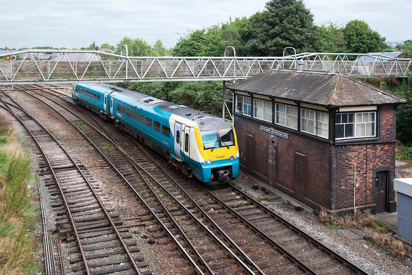 175003, AW 10.40 Holyhead-Llanelli (1V95), Sutton Bridge Junction 
 With the sun trying its hardest to cut through the grey cloud, 175003 accelerates away from Shrewsbury past Sutton Bridge signal box working the 10.40 Holyhead to Llanelli service. This lovely GWR box is a little hidden way but is kept busy operating the signalling for the junction over which a fair number of trains pass. 
 Keywords: 175003 10.40 Holyhead-Llanelli 1V95 Sutton Bridge Junction