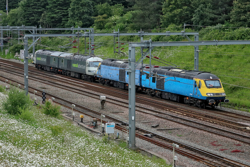 43467, 43423, 43468 & 43480, 12.47 Kings Norton Yard-Wembley Yard (0Z54, 17L), Loughton Redway bridge, Milton Keynes 
 A quartet of HST power cars head south along the WCML at Milton Keynes seen from a footbridge just north of the station. 43467 leads 43423 still wearing their very faded East Midlands Train livery with 43468 and 43480 bringing up the rear. I am not too sure as to why a second pair was heading south as the 0Z54 12.47 King's Norton Yard to Wembley Yard, perhaps there was other work due to come the way of Railadventure later. All I do know is that the smart two power cars would return north later in the evening dragging the final Merseyrail Class 777 to be delivered. 
 Keywords: 43467 43423 43468 43480 12.47 Kings Norton Yard-Wembley Yard 0Z54 Loughton Redway bridge, Milton Keynes HST power cars