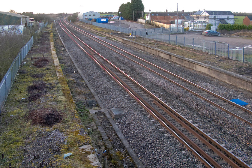 Former Shrivenham station (closed 07.12.64) 
 Despite closing over fifty years ago, the platforms marking the site of Shrivenham station are still clearly intact. The wide gap between the up and down platforms indicates that there were four tracks at this spot. The platforms have just been cleared of extensive vegetation and in preparation for the forthcoming electrification. Is suspect that this is a portent to them being removed to make way for the pilings and posts. 
 Keywords: Former Shrivenham station