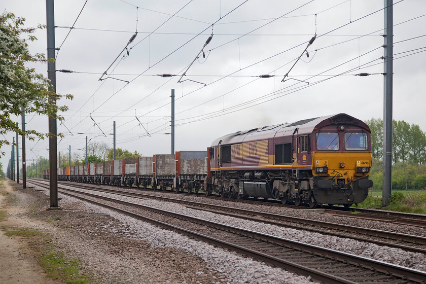 66198, 11.32 Biggleswade-Plasmor Hec (4D56), White House Crossing TL227777 
 66198 ambles along the down slow at White House Crossing north of Huntingdon with the 11.32 Biggleswade to Plasmor Hec. This is a train of flat wagons that will collect sleepers and other concrete products from Plasmor for use on the network somewhere or another! 
 Keywords: 66198 11.32 Biggleswade-Plasmor Hec 4D56 White House Crossing TL227777