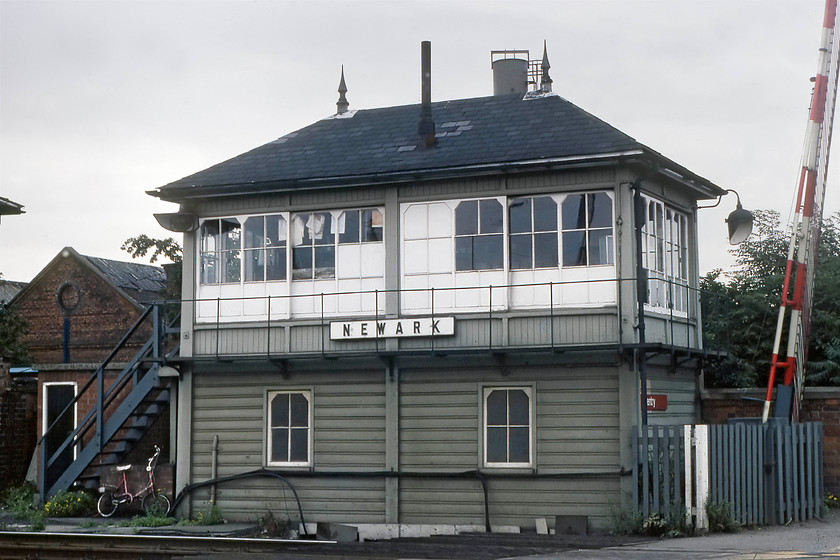 Newark signal box (Midland, 1912) 
 A classic Midland 4a box at Newark Castle. It is situated between the end of the platform to the left and the level crossing over the Great North Road to the right. Just as at Tuxford earlier in the day, the signalman's bike leans against a wall under the signal box steps. However, looking at the bike, could it be a signalwoman? This box is now disused having been closed on 05.11.16, but as of the summer of 2019, it still stands. 
 Keywords: Newark signal box