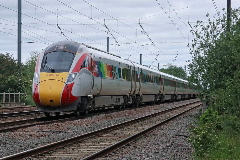 801226, GR 08.00 Edinburgh Waverley-London King's Cross (1E06, 6L), Lolham level crossing 
 801226 'Together' was unveiled as part of Pride Week celebrations in June 2023 wearing its distinctive and bright livery singling it out from the rest of the Azuma fleet. LNER have stated that this livery will be a permanent fixture so like its WCML cousin, 390119 'Pride' it will be seen on the network for some years to come. The Azuma is seen passing Lolham level crossing just south of Tallington working the 1E06 08.00 Edinburgh to King's Cross service. 
 Keywords: 801226 08.00 Edinburgh Waverley-London King's Cross 1E06 Lolham level crossing LNER Azuama Together