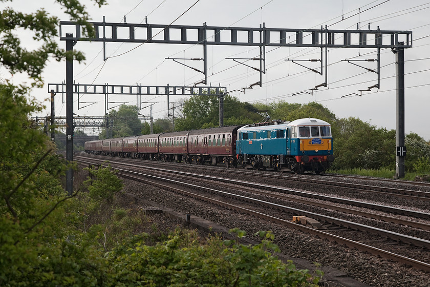 86259, outward leg of The Cumbrian Mountain Express, 07.10 London Euston-Carlisle (1Z86), Ashton Road Bridge 
 Despite the grey skies overhead, I like the lighting in this picture. 86259 'Peter Pan/Les Ross' is nicely framed by the 1950s catenary. It is heading the electric leg of The Cumbrian Mountain Express from London Euston to Carlisle. Like all workings heading north on this morning there were long delays, this charter arrived into Carlisle some 50 minutes late for 35018 'British India Line' to then take the Settle and Carlisle route south again. 
 Keywords: 86259 The Cumbrian Mountain Express 1Z86 Ashton Road Bridge