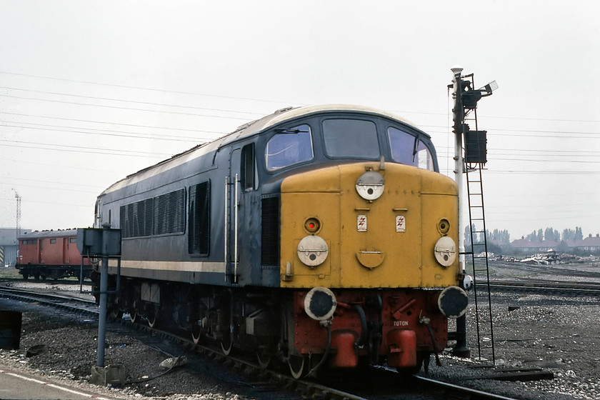 44008, LE, leaving Toton MPD 
 As quickly as it arrived for refuelling, 44008 left the depot again heading off north light engine. Note the additional details such as the red buffer beam and its home depot's name carefully written in white to match its other non-standard adornments. Also, notice that the driver has omitted to extinguish the red tail light in his haste to leave the depot! 
 Keywords: 44008 Toton MPD