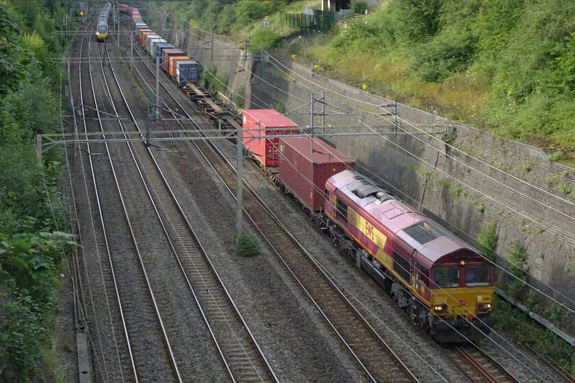 66116, 13.22 Trafford Park-London Gateway (4L56, 7E), Roade cutting 
 At a crawling pace, 66116 leads the 13.22 Trafford Park to London Gateway service through Roade cutting. The EWS liveried and branded Class 66 was smoking badly (even though it's not visible in this photograph) indicating that, along with its slow speed, something was probably amiss. Interestingly, five years ago when I photographed this locomotive I commented on it still carrying the Three Beasties branding, here it is still the same, see... https://www.ontheupfast.com/p/21936chg/28045587004/x66116-10-28-banbury-reservoir-tarmac 
 Keywords: 66116 13.22 Trafford Park-London Gateway 4L56 Roade cutting EWS