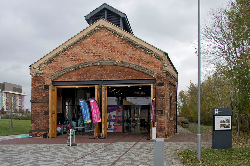 Exterior of The Engine Shed, Students' Union building, UON Riverside campus 
 From the front of the former Midland Railway engine shed it looks a little incongruous with the doors being non-central due to the angled wall on the southern side of the building. This strange quirk of the design was due to the need to have a running line passing very close to the building off to the right to give clearance. The polychrome brickwork is also clear to see in this view that was a rare and what would have been a somewhat costly design feature back in 1872 that took a considerable amount of effort to restore when the building was rescued. During its reconstruction, the historic ventilator lantern was reinstated having been removed many years ago. 
 Keywords: The Engine Shed, Students' Union building UON Riverside campus University of Northampton