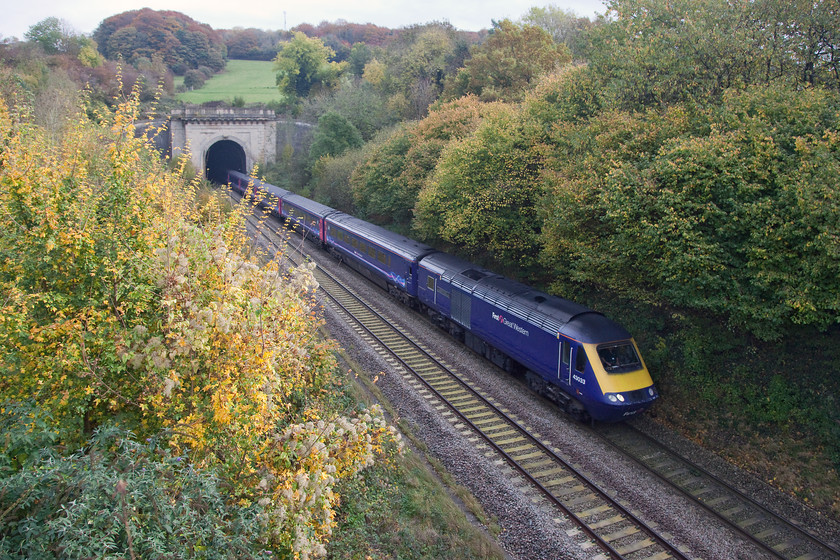 43033, GW 10.30 London Paddington-Bristol Temple Meads (1C10), Box A4 road bridge 
 43033 'Driver Brian Cooper 15 June 1957 - 5 October 1999' emerges into the autumn light from Box Tunnel. The 10.30 Paddington to Bristol Temple Meads is doing its best to prune the lineside vegetation, something that Network Rail must address if they want to avoid problems with trains slipping on the tracks at this time of year. Rather than reducing track speeds, sending leaf busters and Sandite trains out, get teams out to remove the source of the problem! 
 Keywords: 43033 10.30 London Paddington-Bristol Temple Meads 1C10 Box A4 road bridge