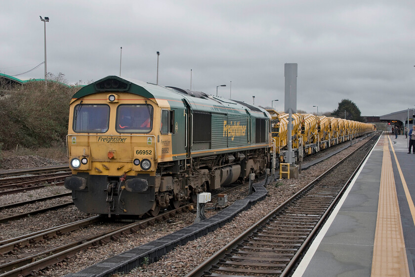 66752, 12.17 Westbury Down TC-Fairwater Yard (6C73, 1L), Westbury station 
 Having gingerly reversed out of Westbury Yard the 12.17 infrastructure train to Fairwater Yard in Taunton waits to leave led by 66742. Both of these locations are at the hub of infrastructure operations in the West Country having grown in importance over the last few years. 
 Keywords: 66752 12.17 Westbury Down TC-Fairwater Yard 6C73 Westbury station Freightliner