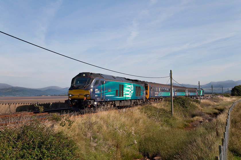 68017 & 68005, NT 06.16 Carlisle-Barrow-in-Furness (2C40, 2E), Carl Cross SD220813 
 In beautiful morning light one of Northern's DRS operated 'super trains', the loco. hauled 06.16 Carlisle to Barrow-in-Furness, passes Carl Cross just south of Kirby-in-Furness. The working was being led by 68017 'Hornet' with 68005 'Defiant' on the rear. This photograph has so many elements from the hills of the southern Lakes, Duddon Sands to the telegraph wires still in situ. Andy and I could happily have spent much longer here and hereabouts but we had to head for home. 
 Keywords: 68017 68005 2C40 Carl Cross SD220813