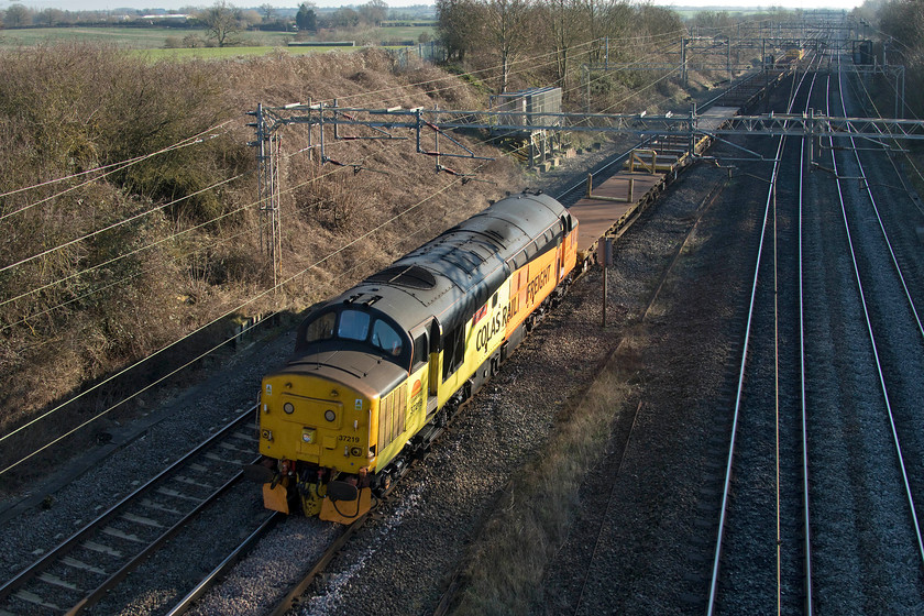 37219 & 37175, 10.57 Willesden-Crewe Basford Hall (6C37), Victoria bridge 
 The third and final infrastructure train to pass Victoria bridge and what a one to finish on! Colas' 37219 'Shirley Ann Smith' leads the 6C37 10.57 Willesden to Crewe Basford Hall empty track flats train. 37175 can be seen bringing up the rear. The driver was giving the lead loco. some beans, I heard it's English Electric soundtrack a fair distance away way before it came into view about two miles away! 
 Keywords: 37219 37175 10.57 Willesden-Crewe Basford Hall 6C37 Victoria bridge