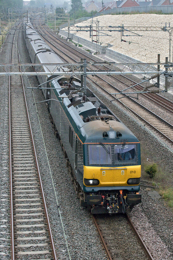 92010, 20.45 Inverness & 19.50 Fort William-London Euston (1M16, 156L), Ashton Road bridge 
 Running over one hundred and fifty minutes late following issues in the Carstairs area as too often appears to be the case, the up Highland Sleeper passes Roade some forty minutes from its destination at Euston. I have travelled on various sleepers but never one running this late. I wonder when this situation occurs if guests are permitted to stay in their cabins for the extra time or if they are woken and asked to vacate at the expected normal time of arrival...advise? 
 Keywords: 92010 20.45 Inverness 19.50 Fort William-London Euston 1M16 Ashton Road bridge Caledonian Sleeper