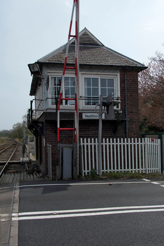 Nunthorpe signal box (NE, 1903) 
 Nunthorpe box is a superb example of a North Eastern structure dating from 1903. It sits on a busy road in the middle of the village that is now more of a suburb to Middlesborough! It controls a number of semaphores and the crossing gates and handles the all-important job of physically handing over and collecting the token enabling trains to continue on to and off the Esk Valley line. I last visited the station when travelling along the line in 1980, see..... https://www.ontheupfast.com/p/21936chg/29786102804/nunthorpe-signal-box-ne-north-eastern 
 Keywords: Nunthorpe signal box