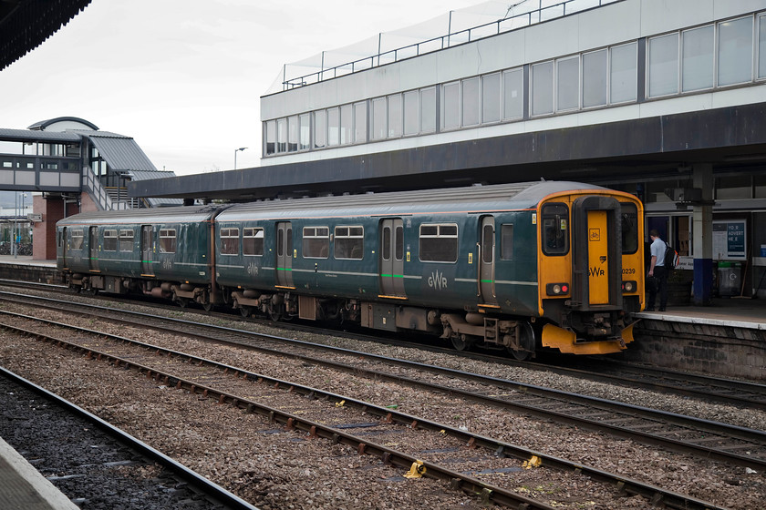 150239, GW 12.42 Gloucester-Frome (2C18, RT), Gloucester station 
 Gloucester station has gone through many changes over the years as fortunes have waxed and wained. The present day station, formally known as Gloucester Central, was re-opened in 1977 with an extended platform designed to take two full rakes of HSTs end to end. This made it the second longest platform on the network only beaten by Colchester. 150239 waits to depart with the 2C18 12.42 to Frome, a convoluted journey requiring a reversal at Bristol Temple Meads. 
 Keywords: 150239 2C18 Gloucester station