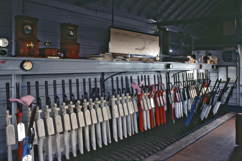 Interior, New Holland Town signal box 
 The sea of white levers in New Holland Town signal box gives a reminder of past times when it would have controlled many more signals and sets of points than it did by this stage in its life just seven days before closure. Despite being in the sunset of its life ninety-six years after its opening the interior remains spick and span complete with a polished linoleum floor! The pink pieces of A4 paper crudely placed over some of the levers are a reminder to the signalmen that they are not to be used. 
 Keywords: Interior New Holland Town signal box