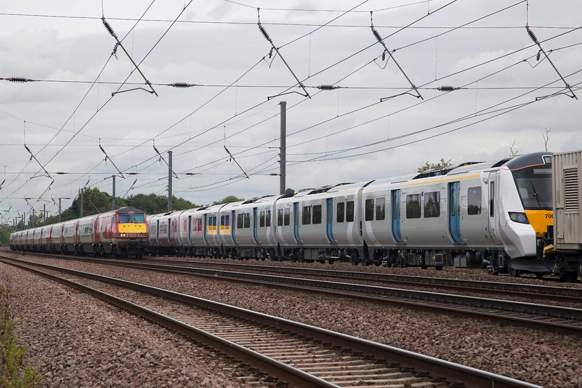 700128, 03.14 Dollands Moor-Hornsey EMUD (Via Peterborough) (6X71) & 82225, GR 08.45 Leeds-LondonKings Cross (1A18, 1E), Offord DArcy TL213655 
 Smelling a fresh paint, 700128 is towed along the ECML at Offord DArcy as the 03.14 Dollands Moor to Hornsey (via Peterborough) 6X71 gauging run. It is being overtaken by the 08.45 Leeds to King's Cross with 82225 nicely reflected in the side of the class 700. 
 Keywords: 700128 03.14 Dollands Moor-Hornsey EMUD 6X71 82225 1A18 Offord DArcy TL213655