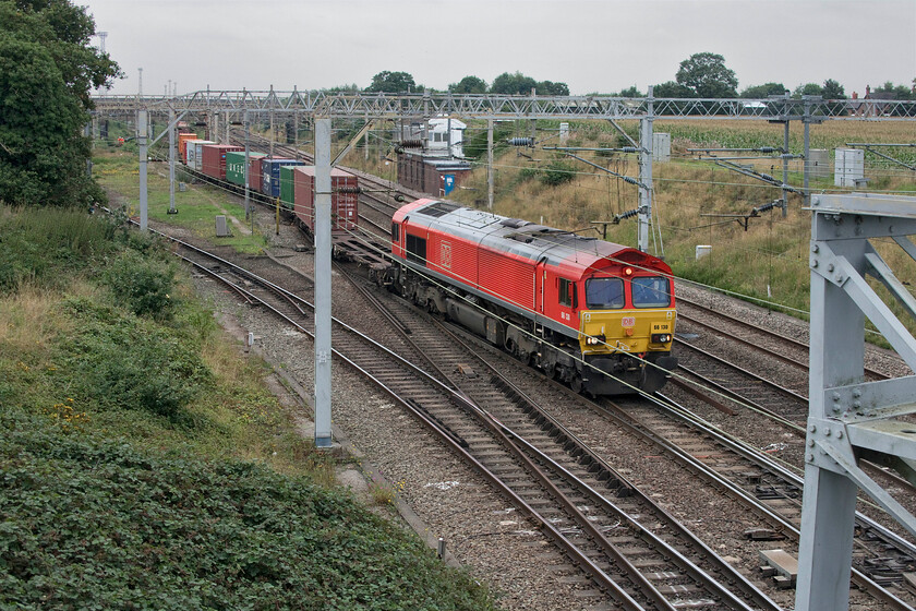 66130, 13.15 Trafford Park-London Gateway (4L56, 19E), Casey Lane SJ720519 
 Having paused in Basford Hall the 4L56 13.25 Trafford Park to London gateway gets underway again hauled by 66130. It is passing the 1897 LNWR Basford Hall Junction signal box that despite all the technology available still manually controls all traffic in and out of the south end of the massive yard. 
 Keywords: 66130 13.15 Trafford Park-London Gateway 4L56 Casey Lane SJ720519 DB