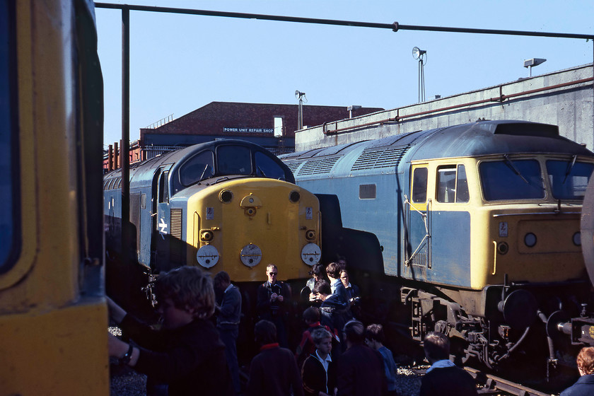 82005, 40029 & 47547, awaiting attention, Crewe Works 
 I am not at all sure where I was standing in order to take this photographs above the heads of the crowds at Crewe Works, it could have been from a cab window or standing on a buffer beam. Either way, this image is nearly spoilt by the young spotter about to cab 82005. The centre of the picture is dominated by 40029 'Saxonia' that is about to be released back into traffic having received collision repairs it sustained at Dewsnap sidings in Hyde on 11.05.79. To the right is 47547 that only carried this and its pre-TOPS number, D1642, throughout its forty-year life span. I cannot find any records as to why it was at Crewe. 
 Keywords: 82005 40029 47547 Crewe Works