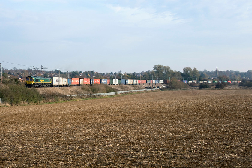 66592, 07.50 Felixstowe North-Lawley Street (4M94), Wilsons Crossing 
 A slightly wider view at Wilson's Crossing near to Kingsthorpe just to the north of Northampton. The image shows 66592 'Johnson Stevens Agencies' leading the 07.50 Felixstowe to Lawley Street Freightliner. This largely rural scene is set to change dramatically over the coming few years. Only the previous week to this picture being recorded, it was announced that Northamptonshire Planners has given approval to a huge housing development of some 3 000 homes to cover the fields in this area. 
 Keywords: 66592 07.50 Felixstowe North-Lawley Street 4M94 Wilsons Crossing